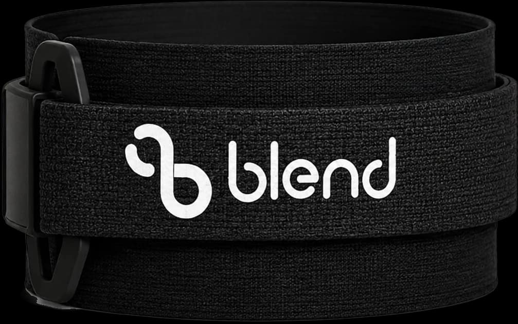 The Blend ankle tracker: a black elasticated band coiled on itself, with a buckle at the left and the Blend wordmark across the strap